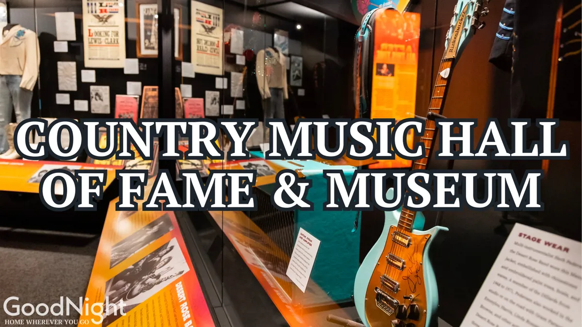 A vibrant interior of the Country Music Hall of Fame featuring historical displays, a guitar, stage wear, and informative posters. The educational, interactive setting invites families to learn about country music’s legacy.